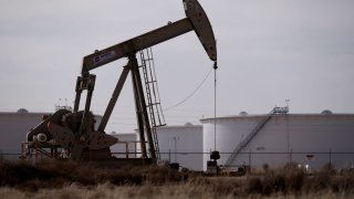 A pump jack operates near a gas turbine power plant in the Permian Basin oil field outside of Odessa, Texas, U.S. February 18, 2025. 
