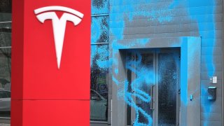 A Tesla car showroom stands doused in blue paint following vandalism by activists of the group New Generation on March 31, 2025 in Berlin, Germany. 