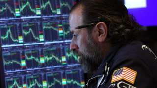 A trader works on the floor of the New York Stock Exchange (NYSE) at the opening bell on April 9, 2025, in New York City.