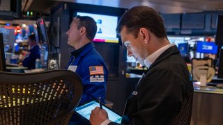 Traders work on the New York Stock Exchange floor on April 28, 2025 in New York City.