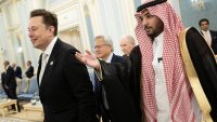 Senior Advisor to the US President Elon Musk (L) and Nvidia CEO Jensen Huang (C) are directed to greet the Saudi Crown Prince at the Royal Court in Riyadh on May 13, 2025.