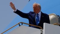 U.S. President Donald Trump gestures, while he boards Air Force One, in Abu Dhabi, United Arab Emirates, May 16, 2025.