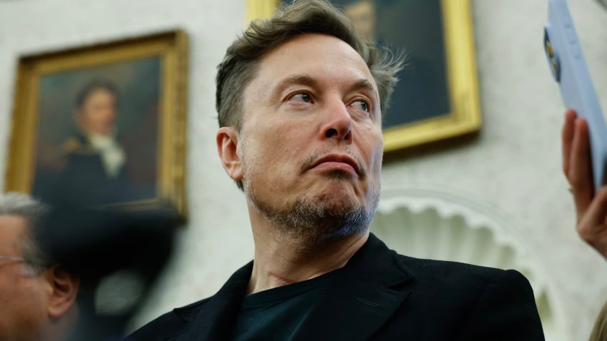 Elon Musk listens as reporters ask U.S. President Donald Trump and South Africa President Cyril Ramaphosa questions during a press availability in the Oval Office at the White House on May 21, 2025 in Washington, DC.