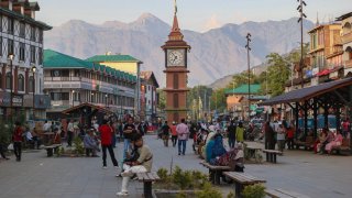 Indian tourists and Kashmiris walk near the clock tower (Ghanta Ghar) in Srinagar, Jammu and Kashmir, on May 28, 2025.