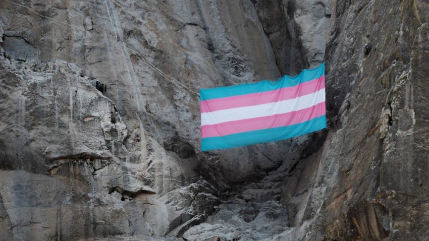 A group of trans, queer and ally climbers unfurled a massive transgender pride flag on the face of Yosemite National Park's iconic El Capitan rock﻿ formation.