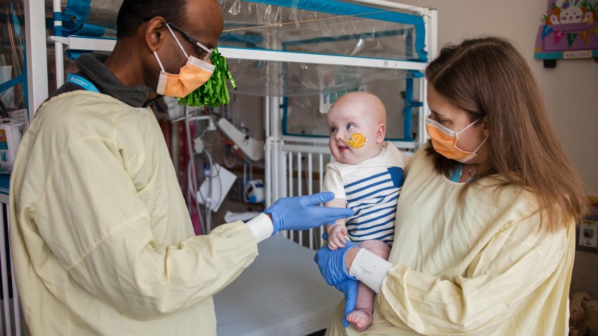 Drs. Musunuru and Ahrens-Nicklas holding KJ after the infusion.”