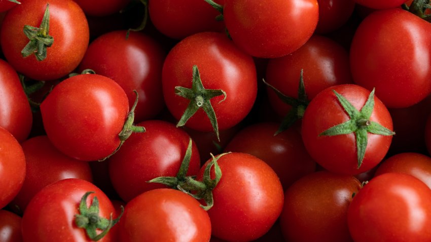 Ripe red cherry tomatoes at a retail market or hypermarket. Vegetarian, vegan and raw food and diet. Organic homemade farm products. Harvesting in the garden, vegetable garden, in the country. Food background. From the farm to the table. Vegetable food.