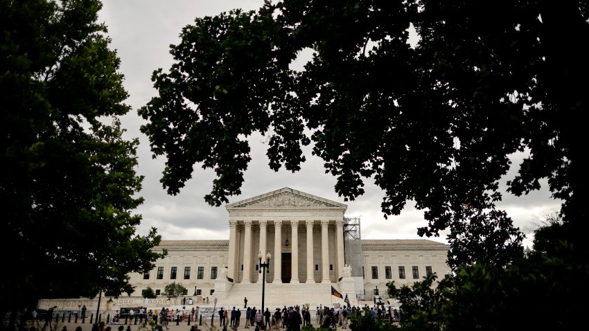 WASHINGTON, DC – JULY 01: Demonstrators, members of the media, and bystanders gather outside the U.S. Supreme Court on July 01, 2024 in Washington, DC. The Supreme Court released its ruling in Trump v. United States, stating that a former president has absolute immunity for official acts but that immunity is not extended for unofficial acts.