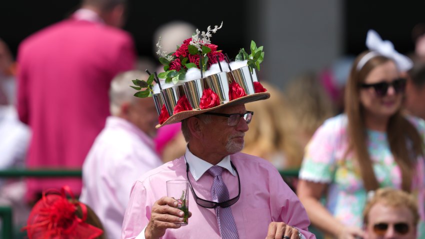 A fan wearing a hat with cups and roses