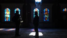 DOLTON, ILLINOIS - MAY 8: Melvin Griggs (L) and Ronald Cashaw talk inside the now closed St. Mary of the Assumption church after Cardinal Robert Prevost was named the new Pope on May 8, 2025 in Dolton, Illinois. Prevost grew up in Dolton and was part of St. Mary of the Assumption church. Prevost will take on the name of Pope Leo XIV.  Pope Leo XIV is originally from Chicago and the first from the United States. (Photo by Joshua Lott/The Washington Post via Getty Images)