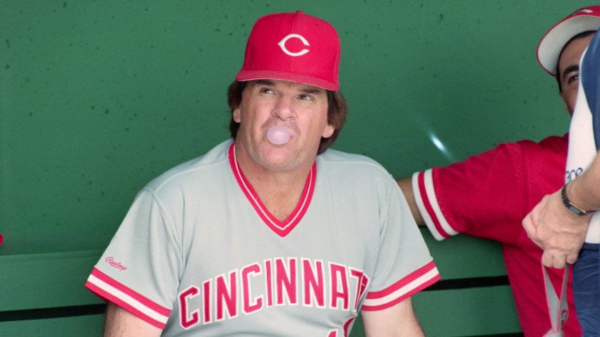 (Original Caption) 3/26/1989-Clearwater, FL- Reds’ manager Pete Rose blows a less than major league bubble as he looks out of the dugout prior to the Reds game against the Phillies. Rose is under investigation by the baseball commissioners office for alleged gambling.