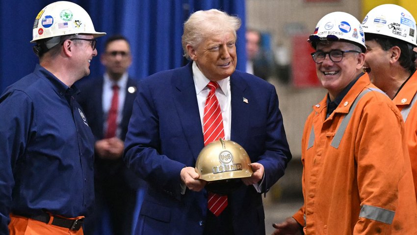 US President Donald Trump receives a gold helmet with his name on it during a visit to U.S. Steel - Irvin Works in West Mifflin, Pennsylvania, May 30, 2025.