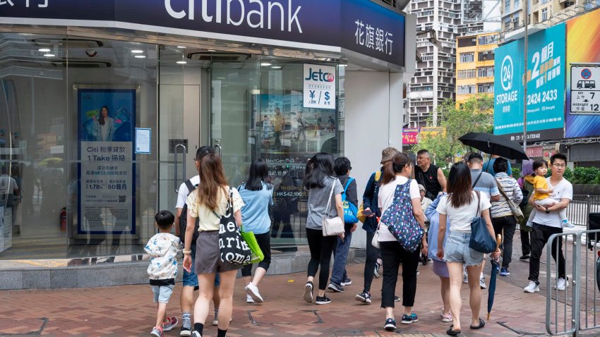 HONG KONG, CHINA – 2024/06/07: Pedestrians walk past the American multinational investment bank, Citibank or Citi, branch in Hong Kong.  