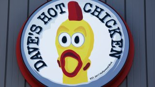 The Dave’s Hot Chicken logo is displayed at a Dave’s Hot Chicken restaurant on February 26, 2025 in Rosemead, California.