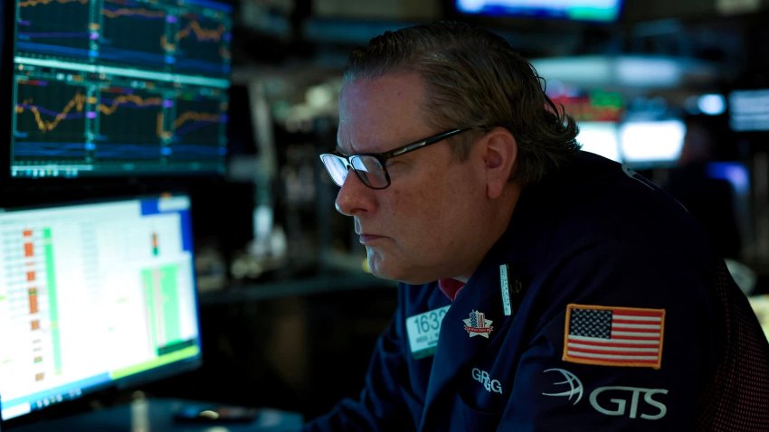 A trader works on the floor of the New York Stock Exchange (NYSE) at the opening bell on May 19, 2025, in New York City.