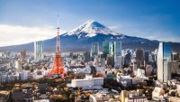 Aerial view of Mt. Fuji, Tokyo Tower and modern skyscrapers in Tokyo on a sunny day.