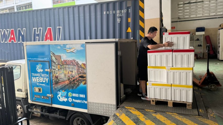 Singapore-based online grocery retailer Webuy staff is offloading containers filled with goods shipped from China.
