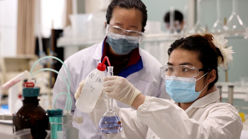 Two graduate students research chemical products in a laboratory in Xiwangzhuang Town, Zaozhuang City, Shandong province of China, on Dec. 26, 2023.