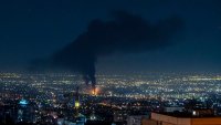 Smoke rises in the distance following an Israeli airstrike in Tehran, Iran, on June 14, 2025.
