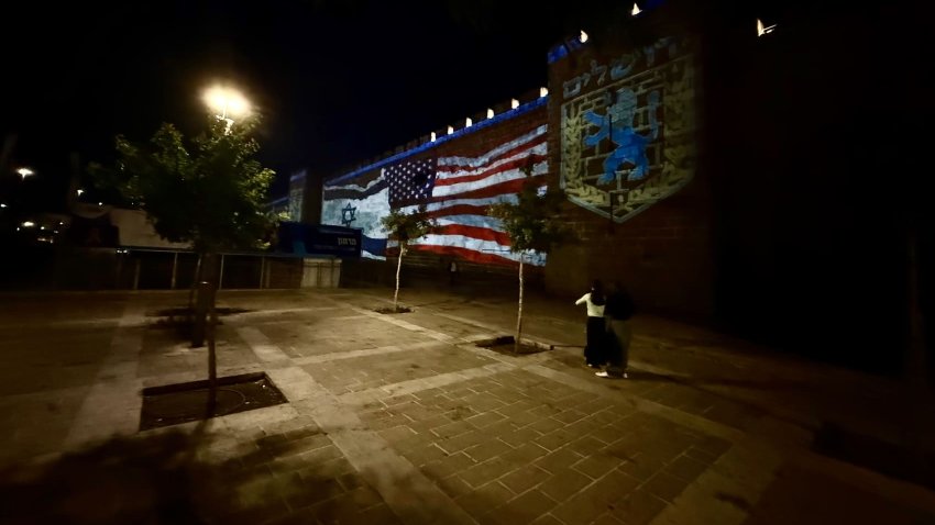 U.S. and Israeli flags projected on the historic walls of the Old City near Hebron Gate in Jerusalem, Israel, on June 22, 2025.
