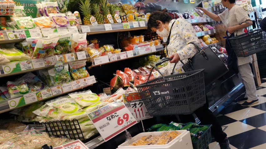 Customers check out vegetables and other groceries at a supermarket in Tokyo on June 20, 2025.