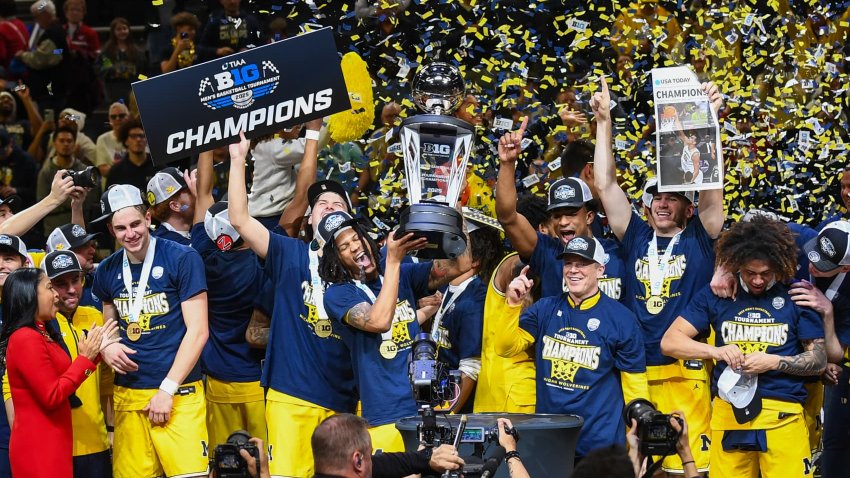 Head coach Dusty May and players of the Michigan Wolverines celebrate after defeating the Wisconsin Badgers in the Big Ten men’s basketball tournament championship game at Gainbridge Fieldhouse on March 16, 2025 in Indianapolis, Indiana.