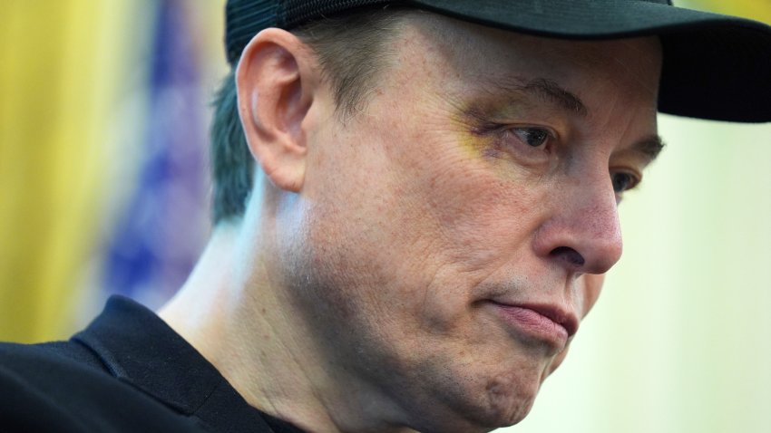 Elon Musk listens as President Donald Trump speaks during a news conference in the Oval Office of the White House, Friday, May 30, 2025, in Washington.