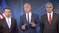 This image from video provided by the Department of Health and Human Services shows Health and Human Services Secretary Robert F. Kennedy Jr. speaking alongside Food and Drug Administration administrator Dr. Martin Makary, left, and Dr. Jay Bhattacharya, director of the National Institutes of Health, as they announce that the government would no longer endorse the COVID-19 vaccine for healthy children or pregnant women.