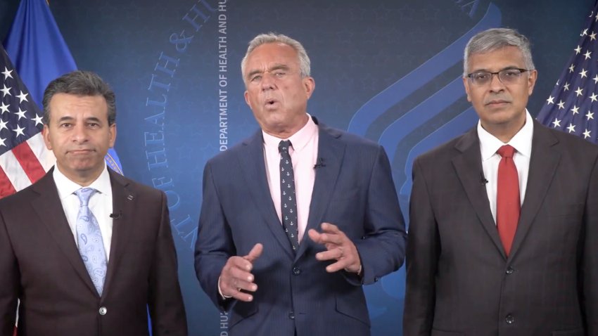 This image from video provided by the Department of Health and Human Services shows Health and Human Services Secretary Robert F. Kennedy Jr. speaking alongside Food and Drug Administration administrator Dr. Martin Makary, left, and Dr. Jay Bhattacharya, director of the National Institutes of Health, as they announce that the government would no longer endorse the COVID-19 vaccine for healthy children or pregnant women.