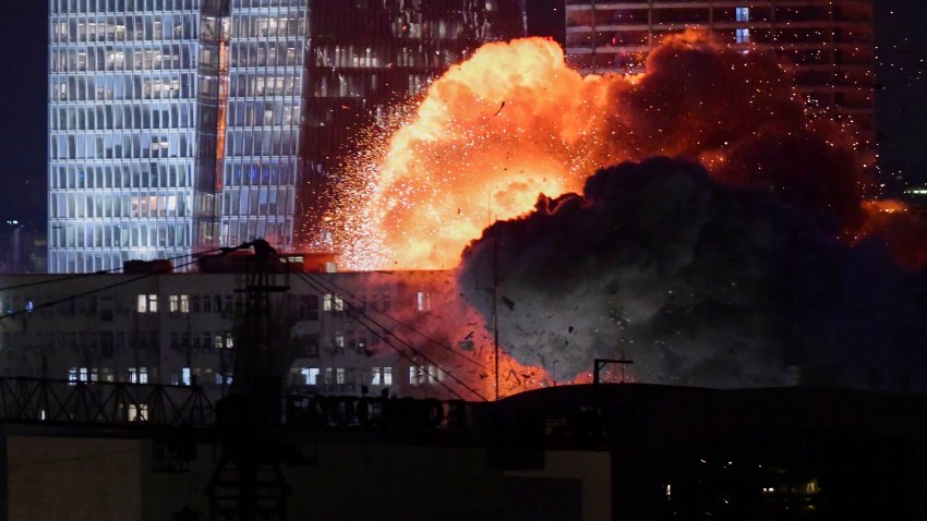 An explosion is seen during a missile attack in Tel Aviv, Israel, Friday, June 13, 2025.