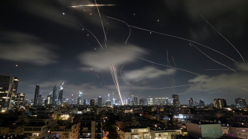 The Israeli Iron Dome air defense system fires to intercept missiles during an Iranian attack over Tel Aviv, Israel, early Wednesday, June 18, 2025.