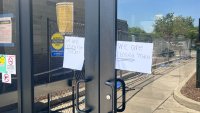 Signs on glass doors outside of a recreation center in Schaumburg that was closed due to a fire. The signs read "We are closed today."