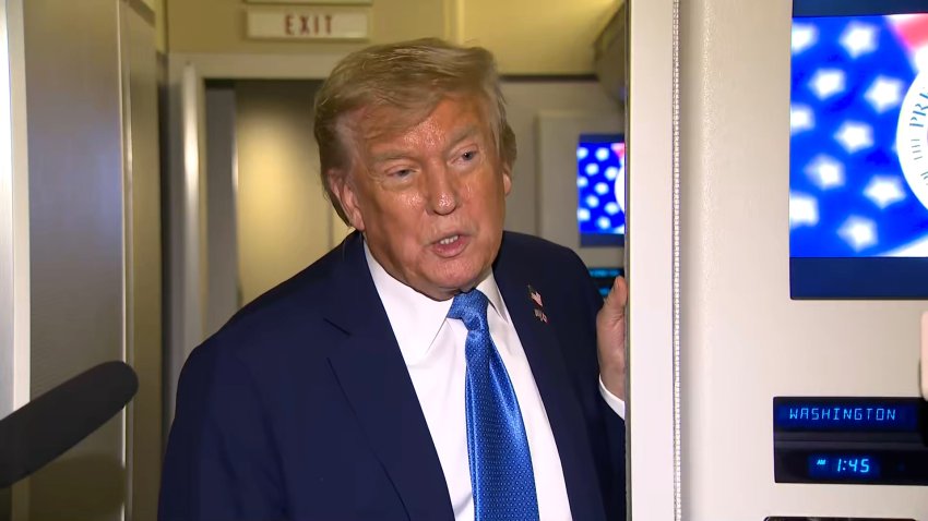 President Donald Trump speaks to reporters on Air Force One