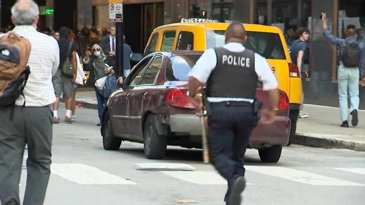 Video: Car drives toward immigration protesters in downtown Chicago