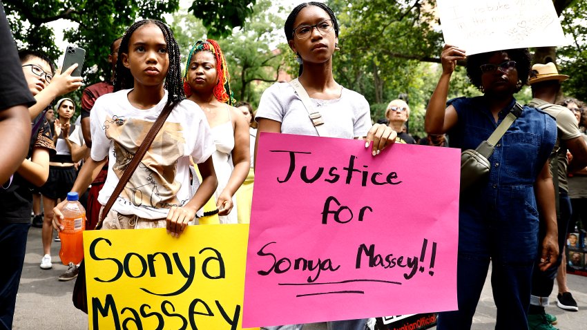 Demonstrators with signs protest the killing of Sonya Massey by a Springfield, Illinois sheriff’s deputy, in Washington Square Park on July 28, 2024 in New York City.