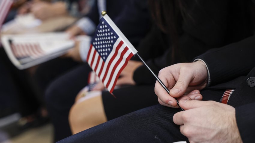 FILE -- A person holds an American flag during a U.S. Citizenship and Immigration Services naturalization ceremony inside the Robert N.C. Nix Federal Courthouse on Oct. 19, 2022, in Philadelphia, Pennsylvania.