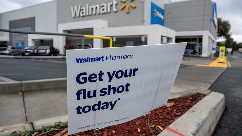 Signage for flu shots outside a Walmart store