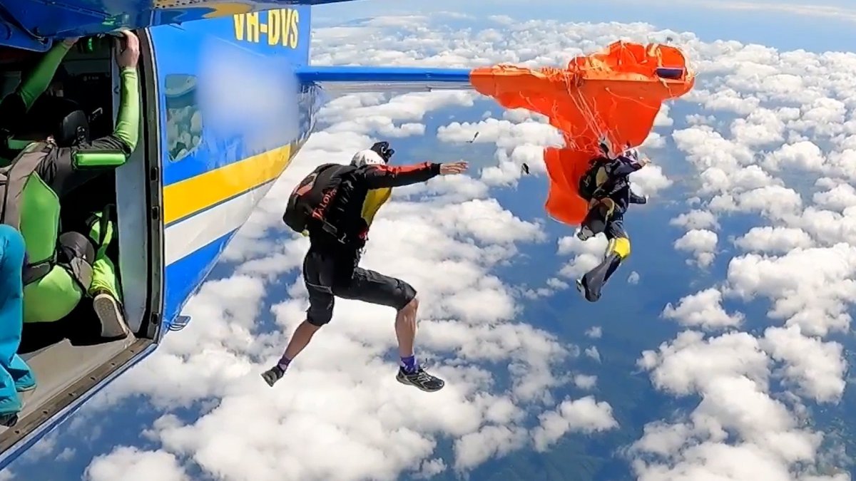 Skydiver dangles at 15,000 feet after parachute catches on plane's tail