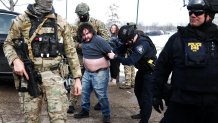Federal agents detain a protester near the Bishop Henry Whipple Federal Building in Minneapolis, Minnesota, on January 9, 2026. A US Immigration and Customs Enforcement (ICE) agent shot and killed an American woman on the streets of Minneapolis January 7, leading to huge protests and outrage from local leaders who rejected White House claims she was a domestic terrorist. The woman, identified in local media as 37-year-old Renee Nicole Good, was hit at point blank range as she apparently tried to drive away from agents who were crowding around her car, which they said was blocking their way. (Photo by CHARLY TRIBALLEAU / AFP via Getty Images)
