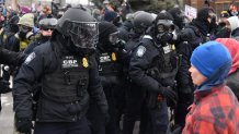 Federal law enforcement agents confront anti-ICE protesters during a demonstration outside the Bishop Whipple Federal Building in Minneapolis, Minnesota, on January 15, 2026. Hundreds more federal agents were heading to Minneapolis, the US homeland security chief said on January 11, brushing aside demands by the Midwestern city's Democratic leaders to leave after an immigration officer fatally shot a woman protester. In multiple TV interviews, US Homeland Secretary Kristi Noem defended the actions of the officer who shot and killed 37-year-old Renee Nicole Good, whose death has sparked renewed protests nationwide against President Donald Trump's immigration crackdown. (Photo by Octavio JONES / AFP via Getty Images)