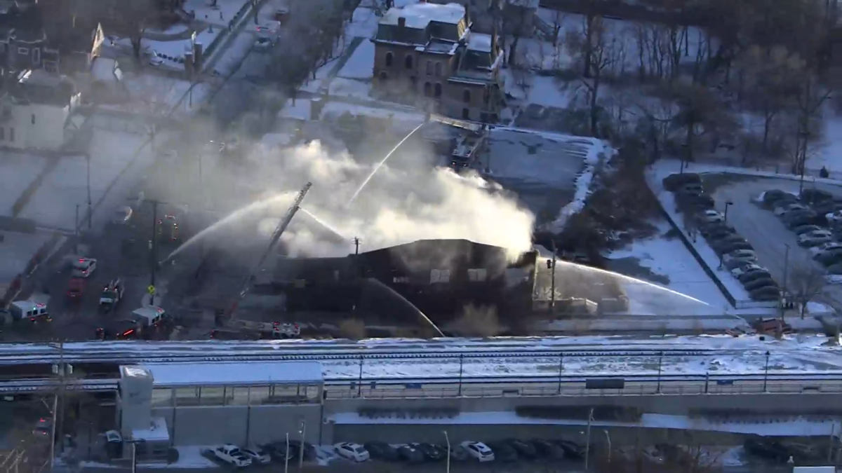 Street blocked as crews fight blaze that partially collapsed suburban building Street blocked as crews fight blaze that partially collapsed suburban building