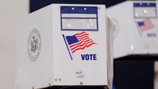 Voting booths at a polling station inside Frank Sinatra School of the Arts High School in the Queens borough of New York, US, on Tuesday, Nov. 4, 2025. New Yorkers heading to the ballot box to select a new mayor face stark choices: a youthful socialist, a seasoned ex-governor or a red-beret-wearing radio host. Photographer: Adam Gray/Bloomberg via Getty Images