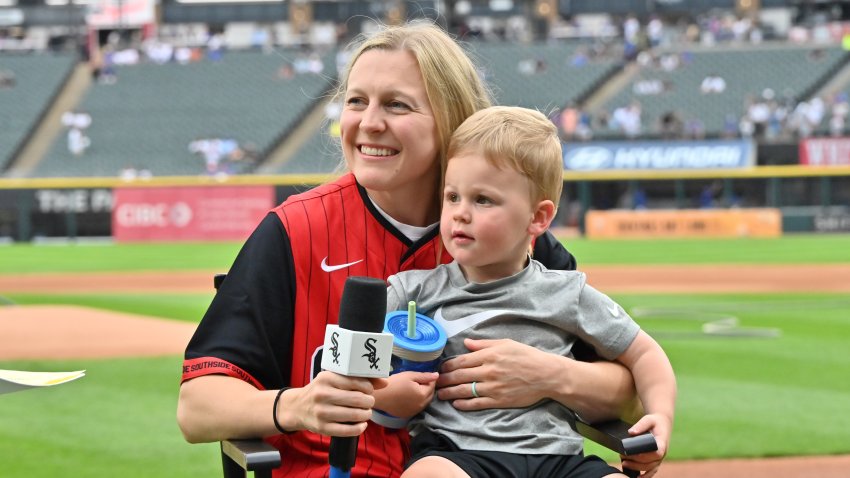 Jul 26, 2025; Chicago, Illinois, USA; American Olympic gold medalist and Captain of the Minnesota Frost Kendall Coyne is interviewed with her son Drew prior to a game between the Chicago White Sox and the Chicago Cubs at Rate Field. Mandatory Credit: Patrick Gorski-Imagn Images