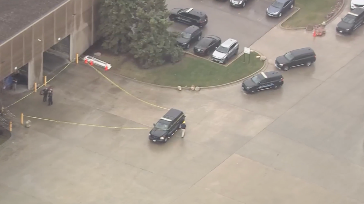 Person dies after becoming trapped underneath crane at suburban business