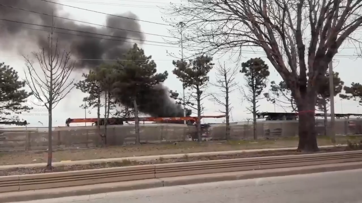 Large plume of dark smoke billows from fire in Chicago rail yard