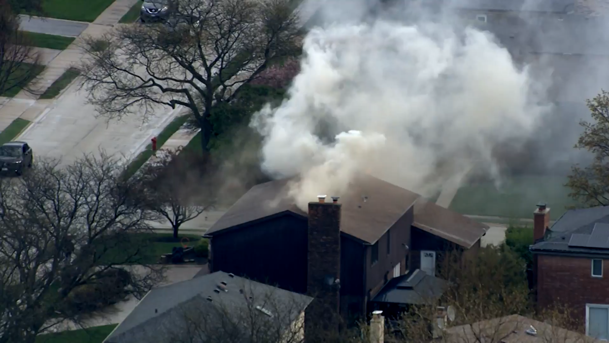 Video shows smoke rise from suburban house fire likely caused by lightning strike