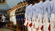 Chinese youth, a military honor guard and military band join Chinese officials to welcome President Donald Trump as he arrives on Air Force One at Beijing Capital International Airport on May 13, 2026 in Beijing, China. President Trump is meeting with President Xi Jinping in Beijing to address the Iran conflict, trade imbalances, and the Taiwan situation while establishing new bilateral boards for economic and AI oversight. 