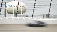 Denny Hamlin drivers through Turn 4 with the Joliet water tower seen in the distance during a Goodyear tire test Wednesday, April 22, 2026, at Chicagoland Speedway in Joliet, Illinois.