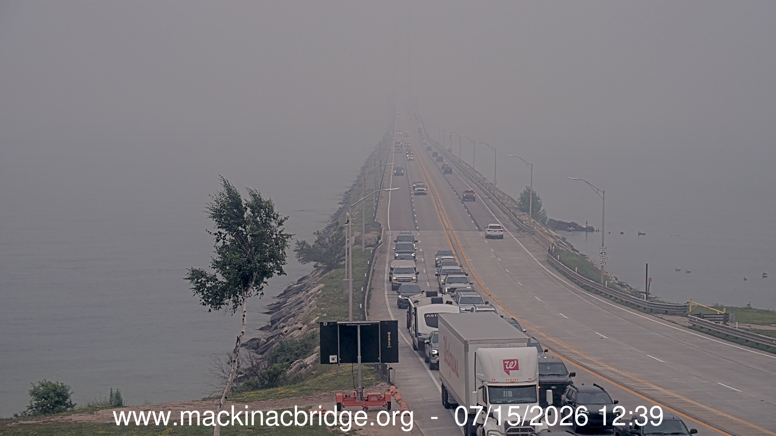 Shocking photos show iconic Mackinac Island bridge disappearing into wildfire smoke