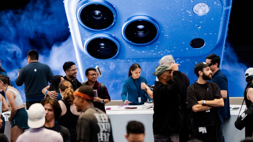 People shop at the Apple store on Fifth Avenue on the day of Apple's launch of the iPhone 18 Pro